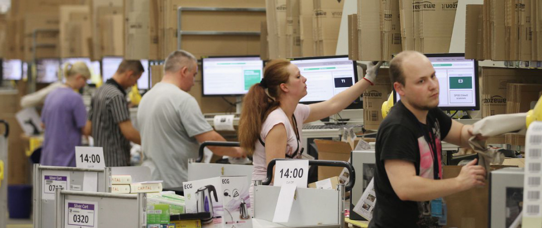 People working in a warehouse using metal products.